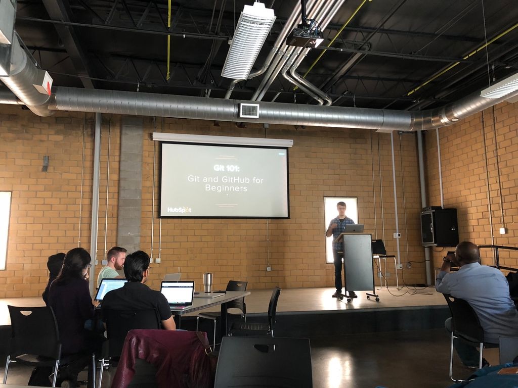 Dan Minshew from TechMill stands at a podium preparing to teach Git and Github for Beginners.